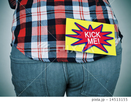 man with a paper with the text kick me in his back 14513155
