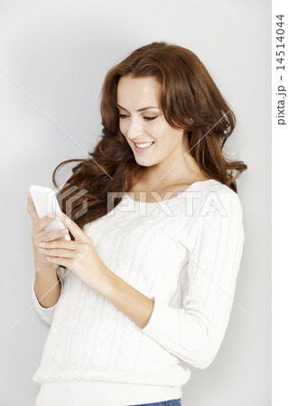 Woman using her smartphone 14514044
