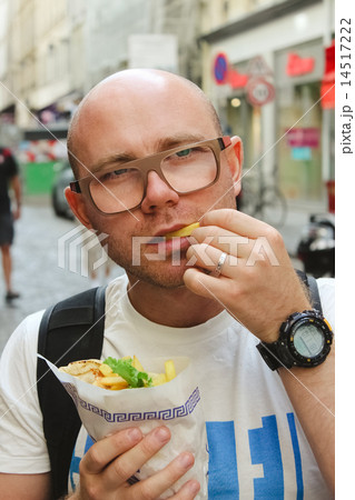 portrait of bald man eating at street 14517222