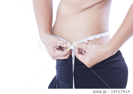 fat woman measuring her stomach  14517414
