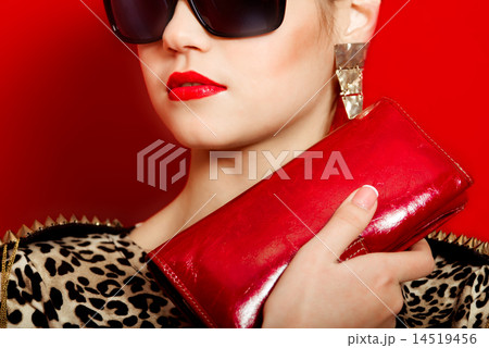 Beautiful girl in a trendy dress and red clutch 14519456