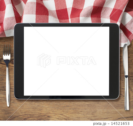 black tablet pc on wooden table with fork and knife 14521653