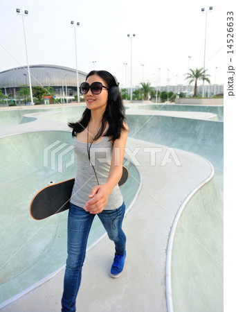 skateboarder walking at skatepark  14526633