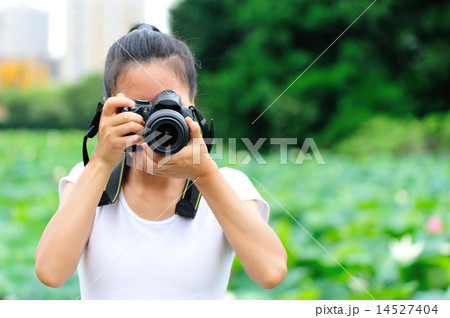 young woman photographer taking photo young woman photographer taking photo 14527404