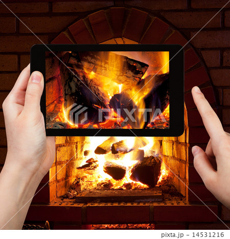 tourist photographs of fire in fireplace 14531216