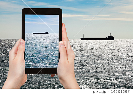 tourist taking photo ship in Black sea in evening 14531597