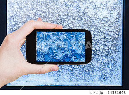 tourist photographs snowflakes and frost on window tourist photographs snowflakes and frost on window 14531648