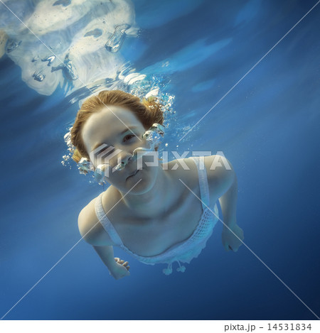 Girl blowing bubbles under water Girl blowing bubbles under water 14531834