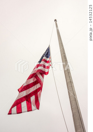 Half mast American flag concept as a symbo  14532125
