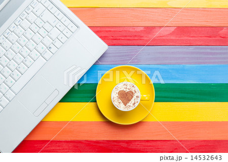 Cup of cappuccino with heart shape and computer Cup of cappuccino with heart shape and computer 14532643