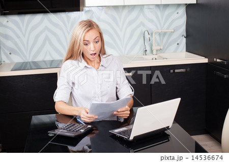 Surprised woman with surprise looks at documents Surprised woman with surprise looks at documents 14536674