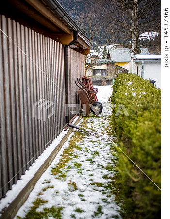 wheelbarrow standing at yard at farm 14537866