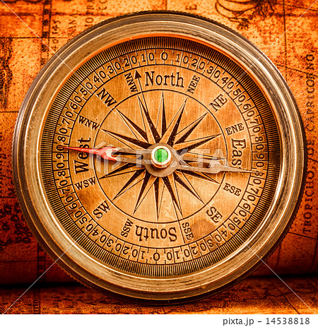 Vintage compass lies on an ancient world map. Vintage compass lies on an ancient world map. 14538818