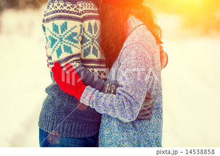 Young couple wearing a sweaters hugging outdoors 14538858