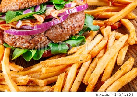 Burger and french fries on wooden background. Burger and french fries on wooden background. 14541353