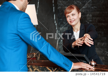 Guest communicating with a receptionist 14541719