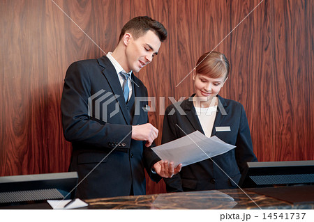 Hotel receptionists behind the counter Hotel receptionists behind the counter 14541737