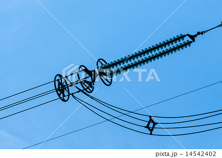 Close-up of power line insulators on sky Close-up of power line insulators on sky 14542402