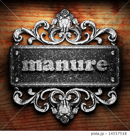 manure word of iron on wooden background 14557538