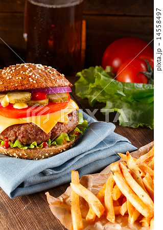 Burger and french fries on wooden background. 14558497