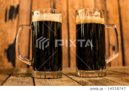 Two glass of fresh dark beer on wooden table. 14558747