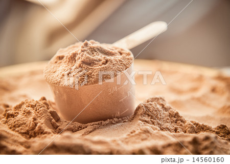 A scoop of chocolate whey isolate protein. A scoop of chocolate whey isolate protein. 14560160