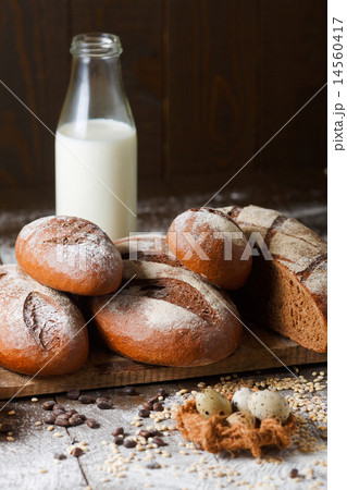 Variety of rye bread on a wooden background with milk 14560417