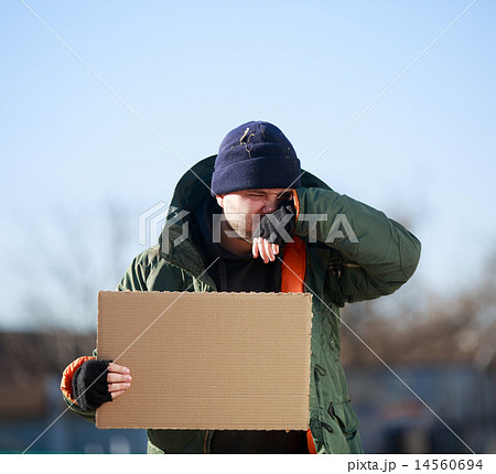 Homeless man holds blank cardboard for your own text 14560694