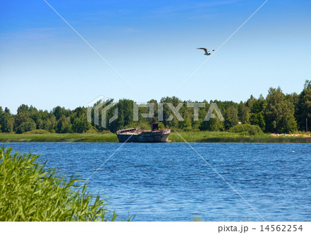 The old cargoship on the river bank Luga. Russia.. The old cargoship on the river bank Luga. Russia.. 14562254