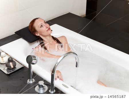 woman lays in soapsuds in bathing, full water woman lays in soapsuds in bathing, full water 14565187