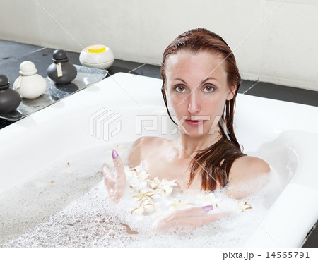 woman lays in soapsuds in bathing, full water woman lays in soapsuds in bathing, full water 14565791
