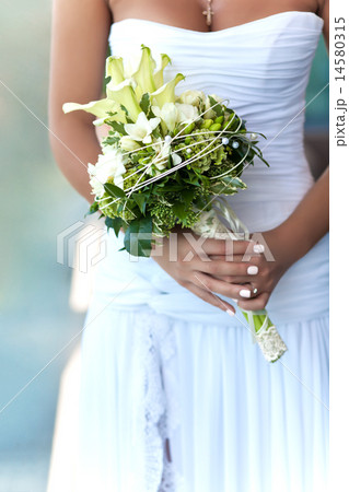 bouquet of white wedding flowers in bride's hands 14580315