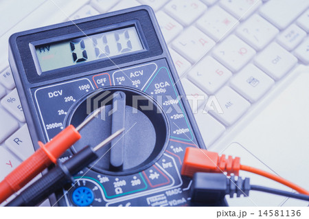 multimeter on the white laptop. close-up 14581136
