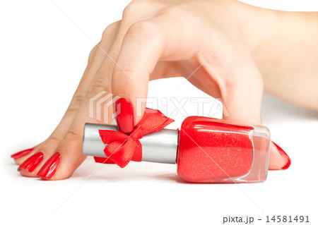 woman's hand with a bottle of red nail polish woman's hand with a bottle of red nail polish 14581491