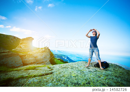 young tourist looks for way from the rocks top 14582726
