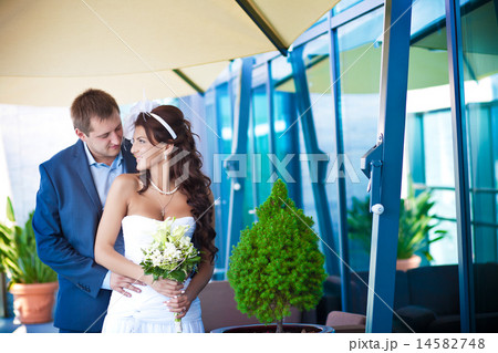 bride and groom is hugging near the glass wall bride and groom is hugging near the glass wall 14582748