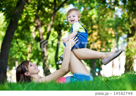 funny baby with mom in a greenl summer park funny baby with mom in a greenl summer park 14582749