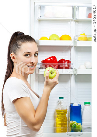 attractive girl near the open refrigerator attractive girl near the open refrigerator 14584017