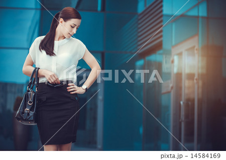 Business woman walking outside in city Business woman walking outside in city 14584169
