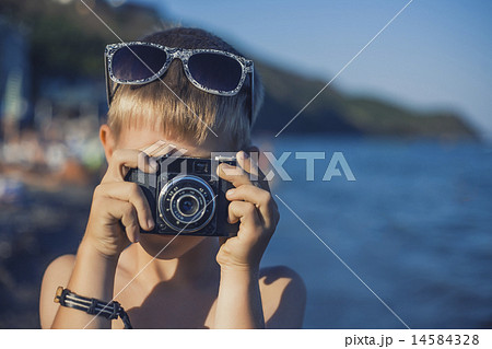 trendy boy photographer on the beach 14584328