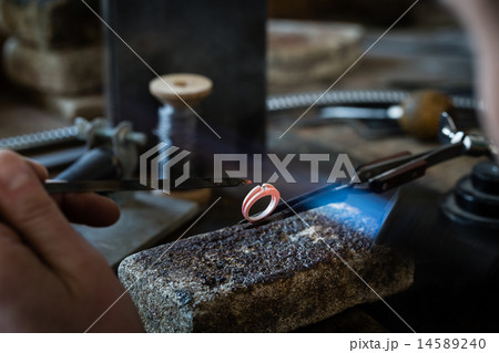 Craft jewelery making with flame torch. 14589240