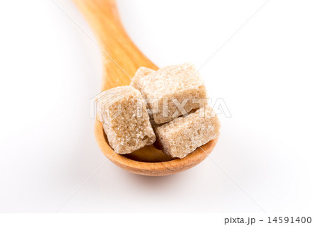 brown sugar in a wooden spoon brown sugar in a wooden spoon 14591400