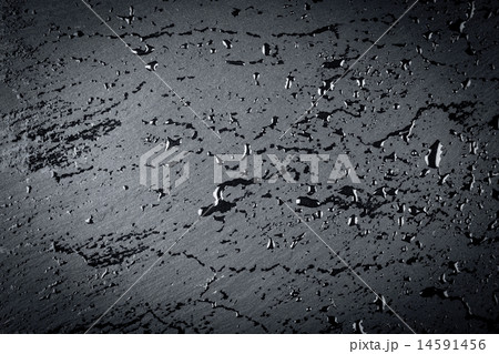 water on dark stone surface 14591456