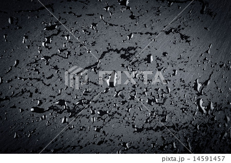 water on dark stone surface 14591457