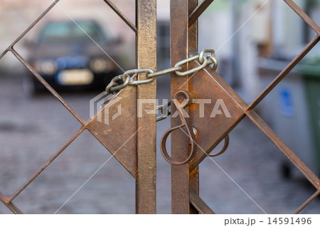 Old metal lock on chain Old metal lock on chain 14591496