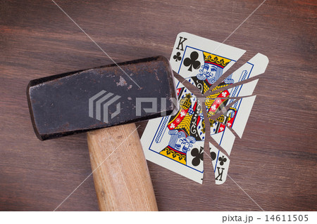 Hammer with a broken card, king of clubs 14611505