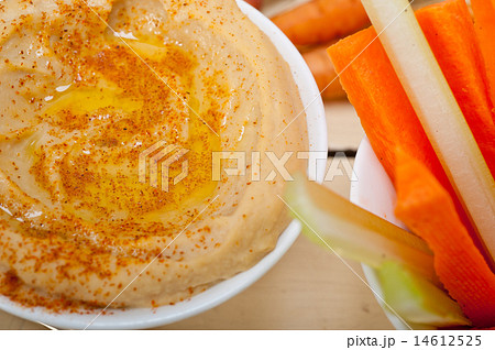 fresh hummus dip with raw carrot and celery 14612525