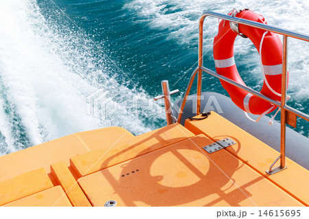 Red lifebuoy hanging on railings of rescue boat 14615695