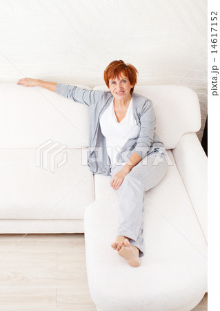 Happy mature woman on sofa Happy mature woman on sofa 14617152