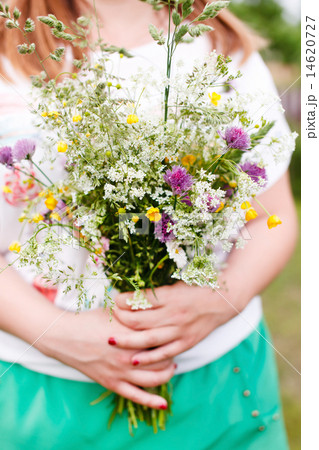 Woman holding wild flowers 14620727